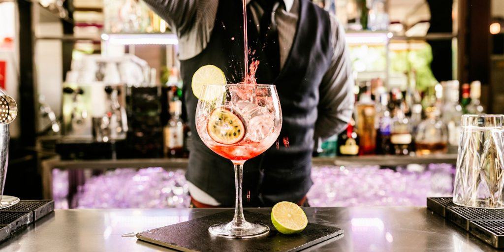 Bartender at Work - A skilled bartender preparing a cocktail, adding an element of sophistication.
