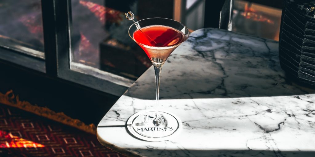 A Grand Martiny's cocktail on top of a white marble surface