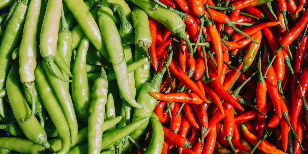 Close up top view of green and red chillies