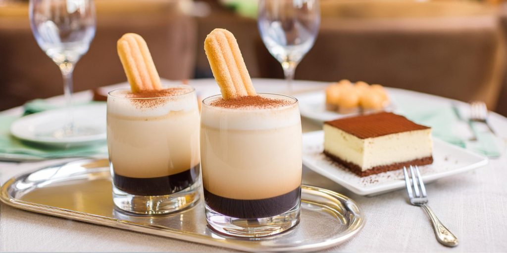 Two Tiramisu White Russian variations served with lady finger biscuits and a slice of tiramisu on the side