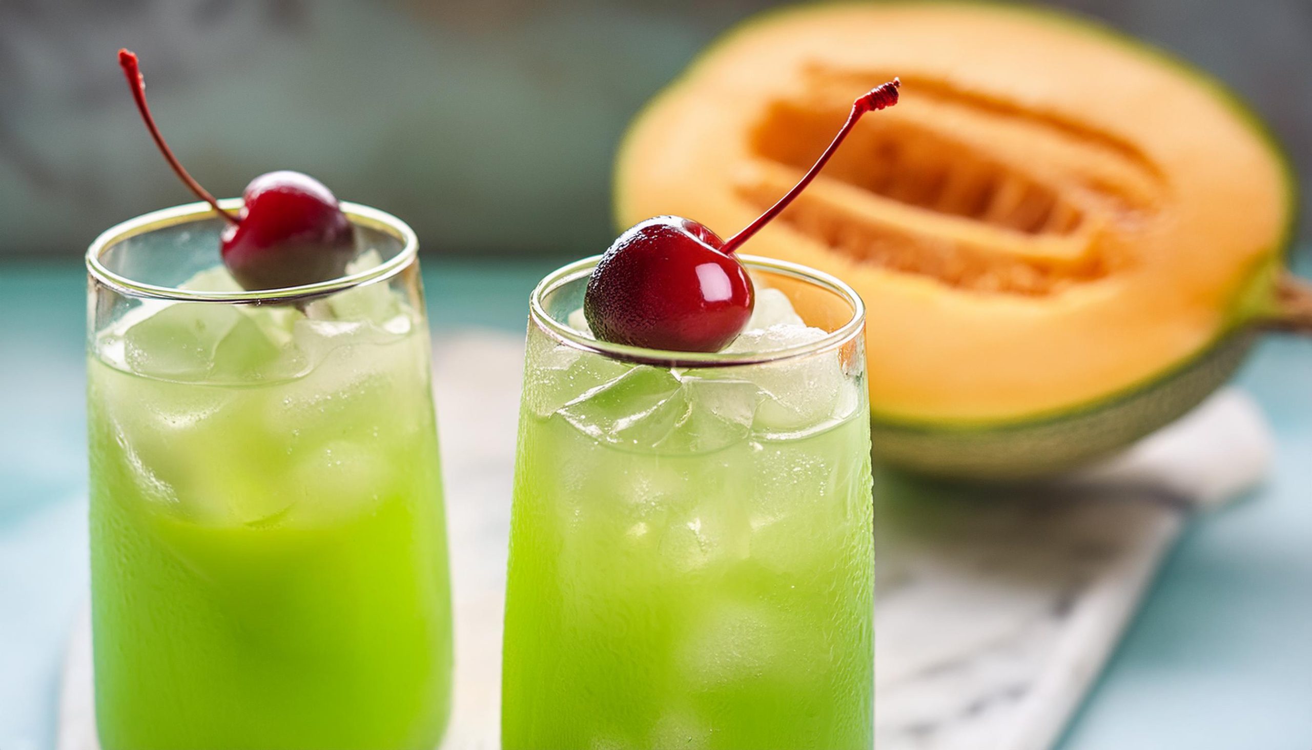 Two Tokyo Tea cocktails with luxardo cherry garnish